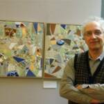 Ken Cotlar poses next to his works